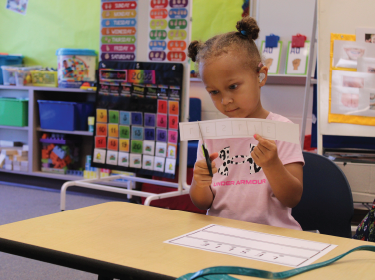 Girl cutting pieces of paper